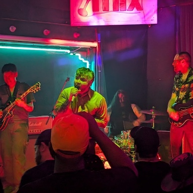 Three musicians playing at a night club